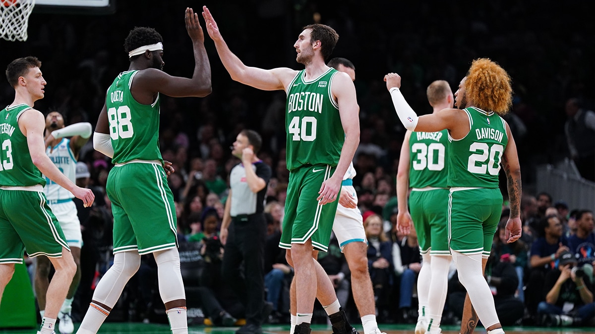 Boston Celtics center Neemias Queta (88) and center Luke Kornet (40) react after a play against the Charlotte Hornets in the second half at TD Garden.