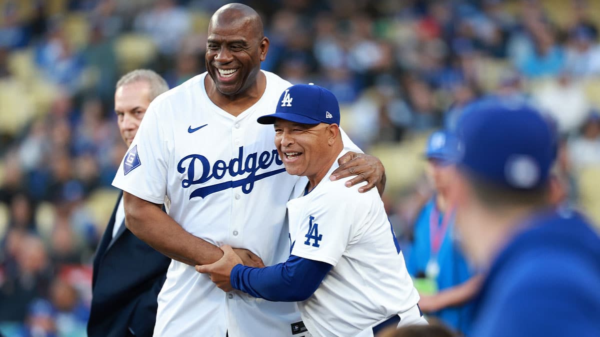 California, USA; Magic Johnson (L) is greeted by Los Angeles Dodgers manager Dave Roberts (R) before the game against the Washington Nationals at Dodger Stadium.