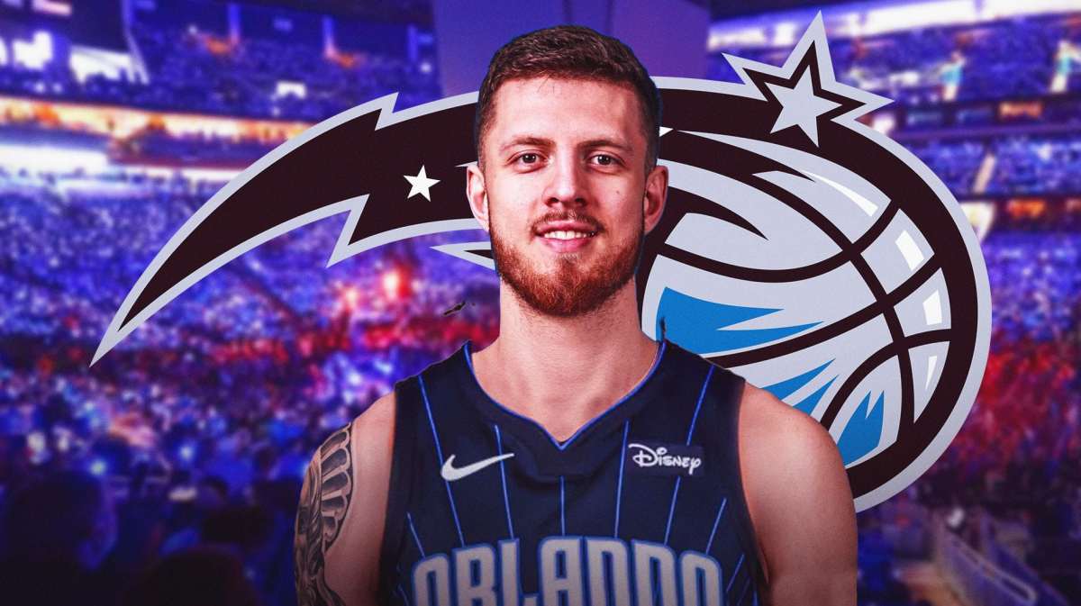 Isaiah Hartenstein wearing Orlando Magic Jersey. Orlando Magic logo in the background.