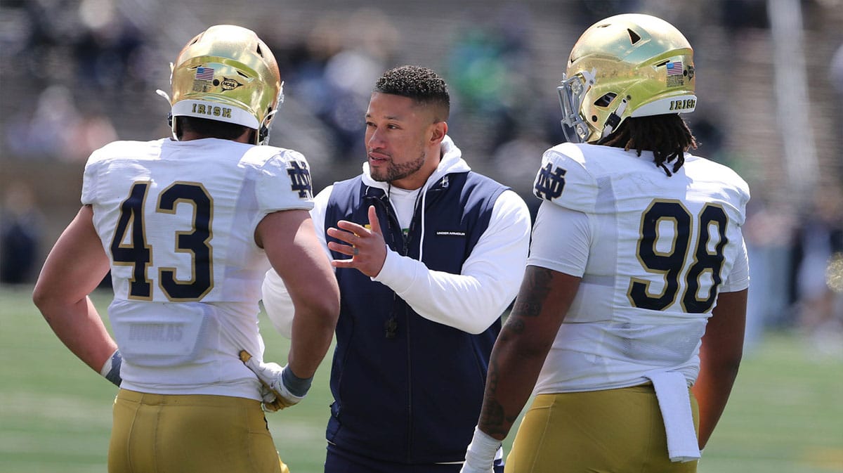 Notre Dame Head Coach Marcus Freeman speaks to Kahanu Kia (43) and Devan Houstan (98) Saturday, April 20, 2024, at the annual Notre Dame Blue-Gold spring football game at Notre Dame Stadium in South Bend.