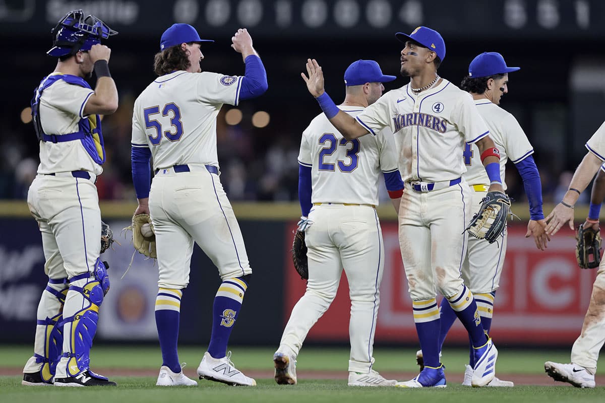 Seattle Mariners center fielder Julio Rodríguez, right, greets pitcher Mike Baumann (53) a win over the Los Angeles Angels at T-Mobile Park. 
