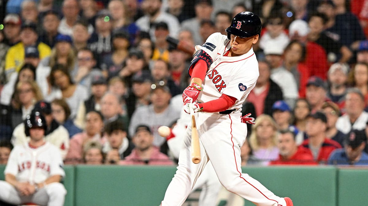 Boston Red Sox left fielder Masataka Yoshida (7) hits a RBI single against the Chicago Cubs during the third inning at Fenway Park. 