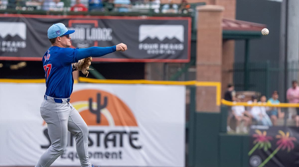 Chicago Cubs infielder Matt Shaw (77) throws to first base in the first inning during a spring training game against the San Francisco Giants at Scottsdale Stadium