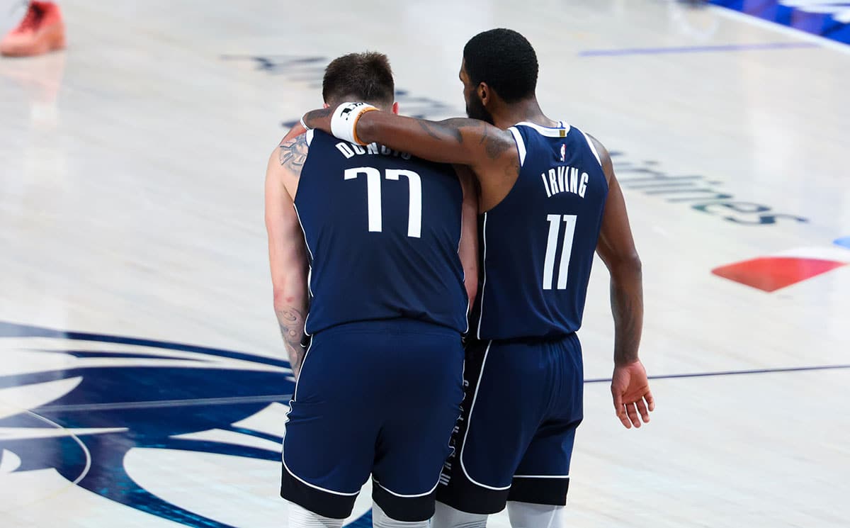 Dallas Mavericks guard Luka Doncic (77) and Dallas Mavericks guard Kyrie Irving (11) hug during the fourth quarter against the Minnesota Timberwolves during game three of the western conference finals for the 2024 NBA playoffs at American Airlines Center. 