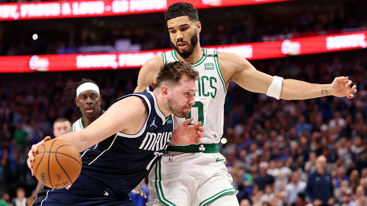 Dallas Mavericks guard Luka Doncic (77) dribbles the ball against Boston Celtics forward Jayson Tatum (0) during the fourth quarter during game three of the 2024 NBA Finals at American Airlines Center