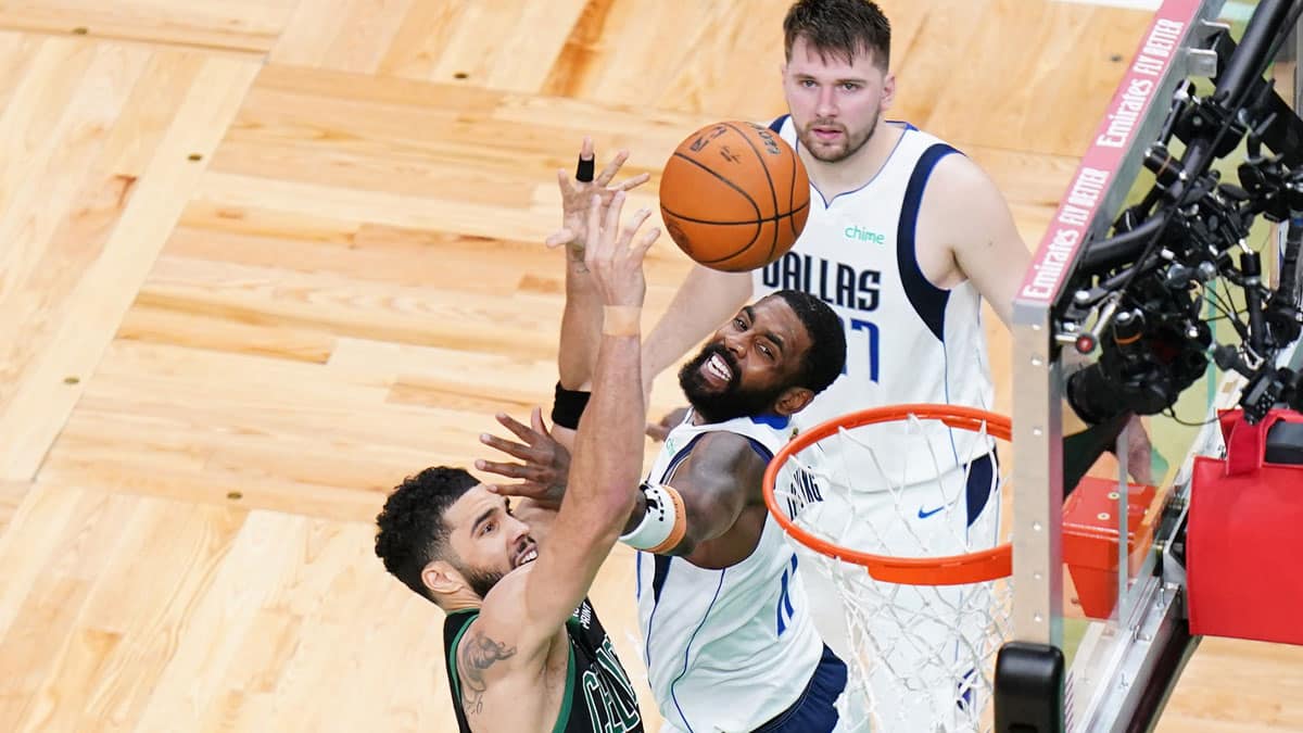 Boston Celtics forward Jayson Tatum (0) shoots against Dallas Mavericks guard Kyrie Irving (11) 