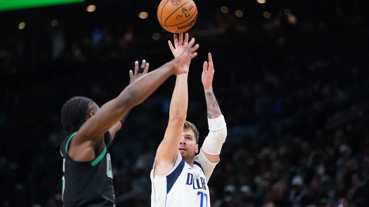 Dallas Mavericks guard Luka Doncic (77) shoots against Boston Celtics guard Jaylen Brown (7) in the first quarter at TD Garden
