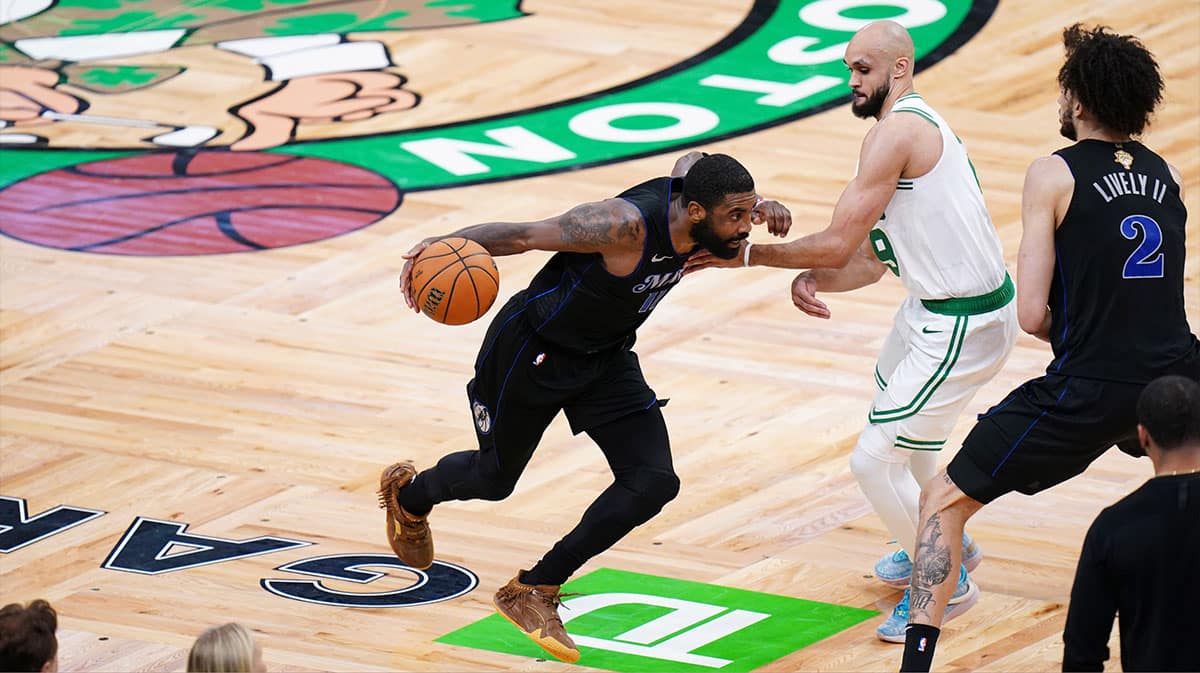 Dallas Mavericks guard Kyrie Irving (11) controls the ball against Boston Celtics guard Derrick White (9) in the fourth quarter during game one of the 2024 NBA Finals at TD Garden.