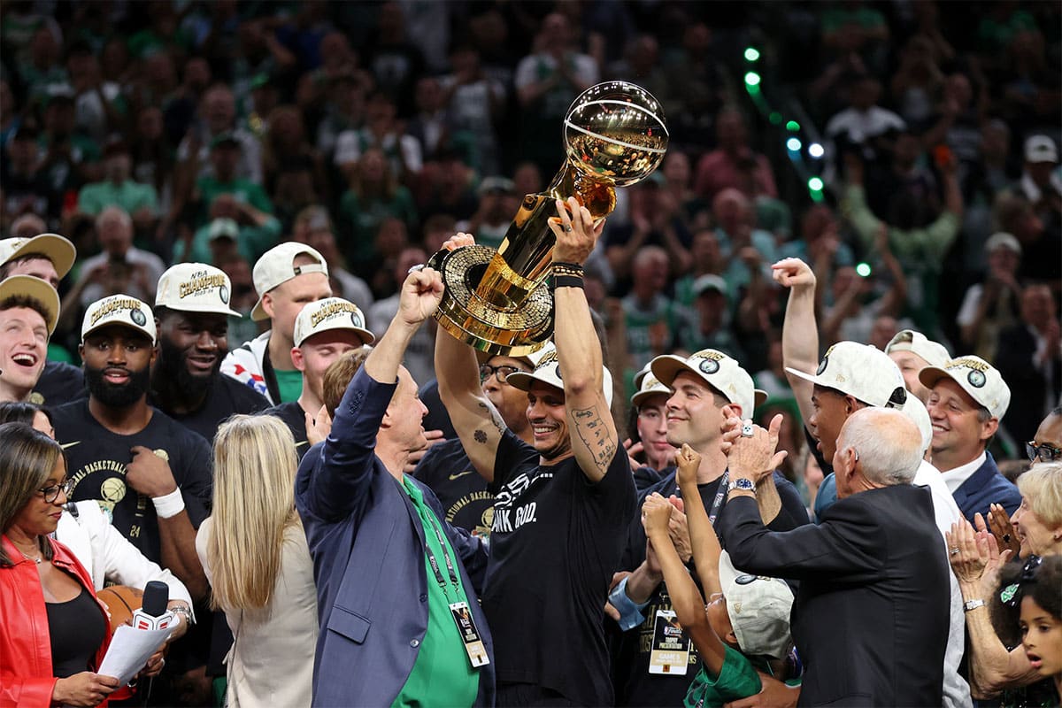  Boston Celtics head coach Joe Mazzulla holds up the trophy as he celebrates after winning the 2024 NBA Finals against the Dallas Mavericks at TD Garden