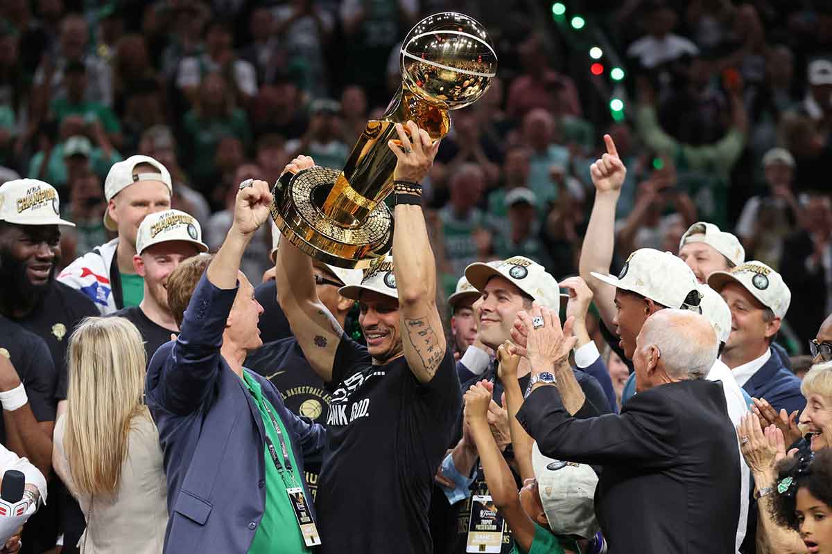 Boston, Massachusetts, USA; Boston Celtics head coach Joe Mazzulla holds up the trophy as he celebrates after winning the 2024 NBA Finals against the Dallas Mavericks at TD Garden. 