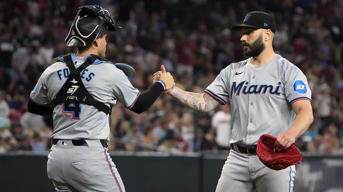 Miami Marlins catcher Nick Fortes (4) and pitcher Tanner Scott (66) celebrate after defeating the Arizona Diamondbacks at Chase Field.