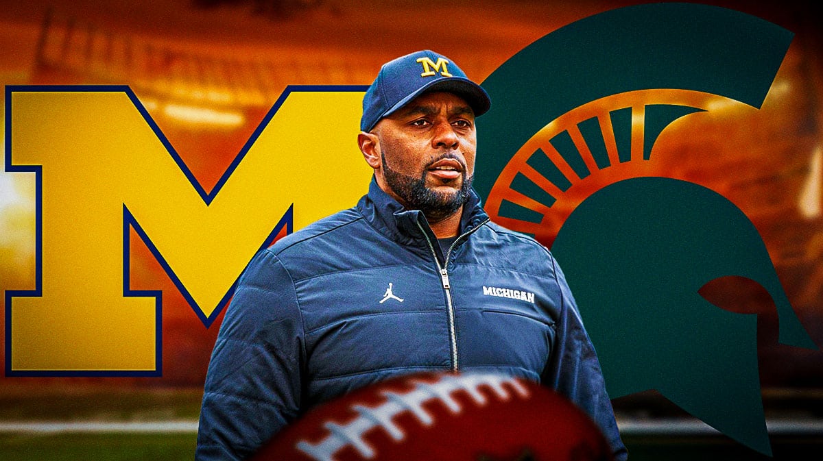 Michigan football coach Sherrone Moore, with Michigan and Michigan State logos behind him.