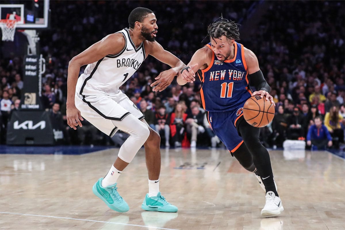 New York Knicks guard Jalen Brunson (11) drives past Brooklyn Nets forward Mikal Bridges (1) in the third quarter at Madison Square Garden.