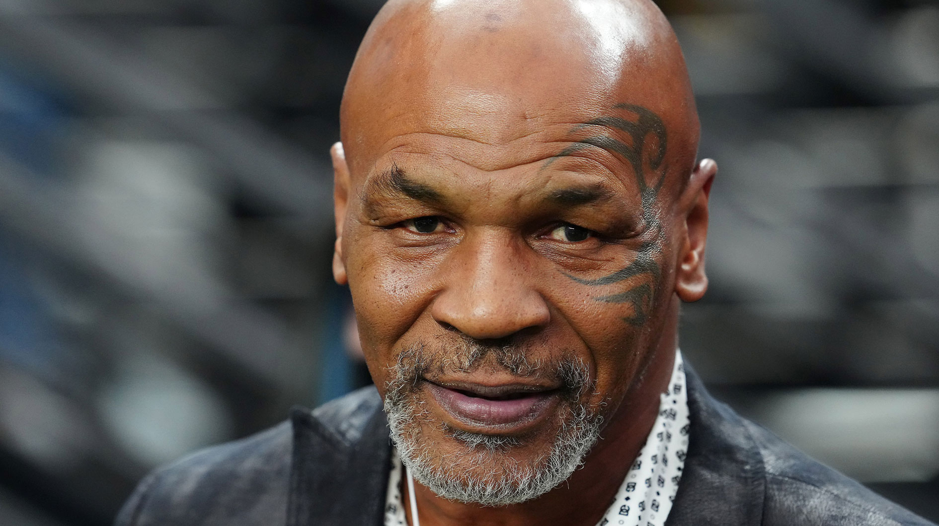 Mike Tyson poses for a photo on the sidelines before the start of a game between the Las Vegas Raiders and the Pittsburgh Steelers at Allegiant Stadium. 