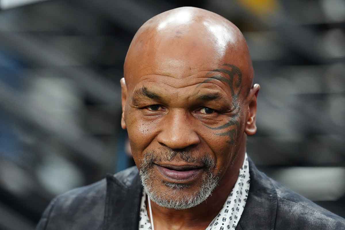 Mike Tyson poses for a photo on the sidelines before the start of a game between the Las Vegas Raiders and the Pittsburgh Steelers at Allegiant Stadium.