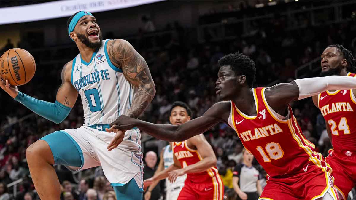 Charlotte Hornets forward Miles Bridges (0) tries to shoot over Atlanta Hawks forward Mouhamed Gueye (18) during the second half at State Farm Arena.
