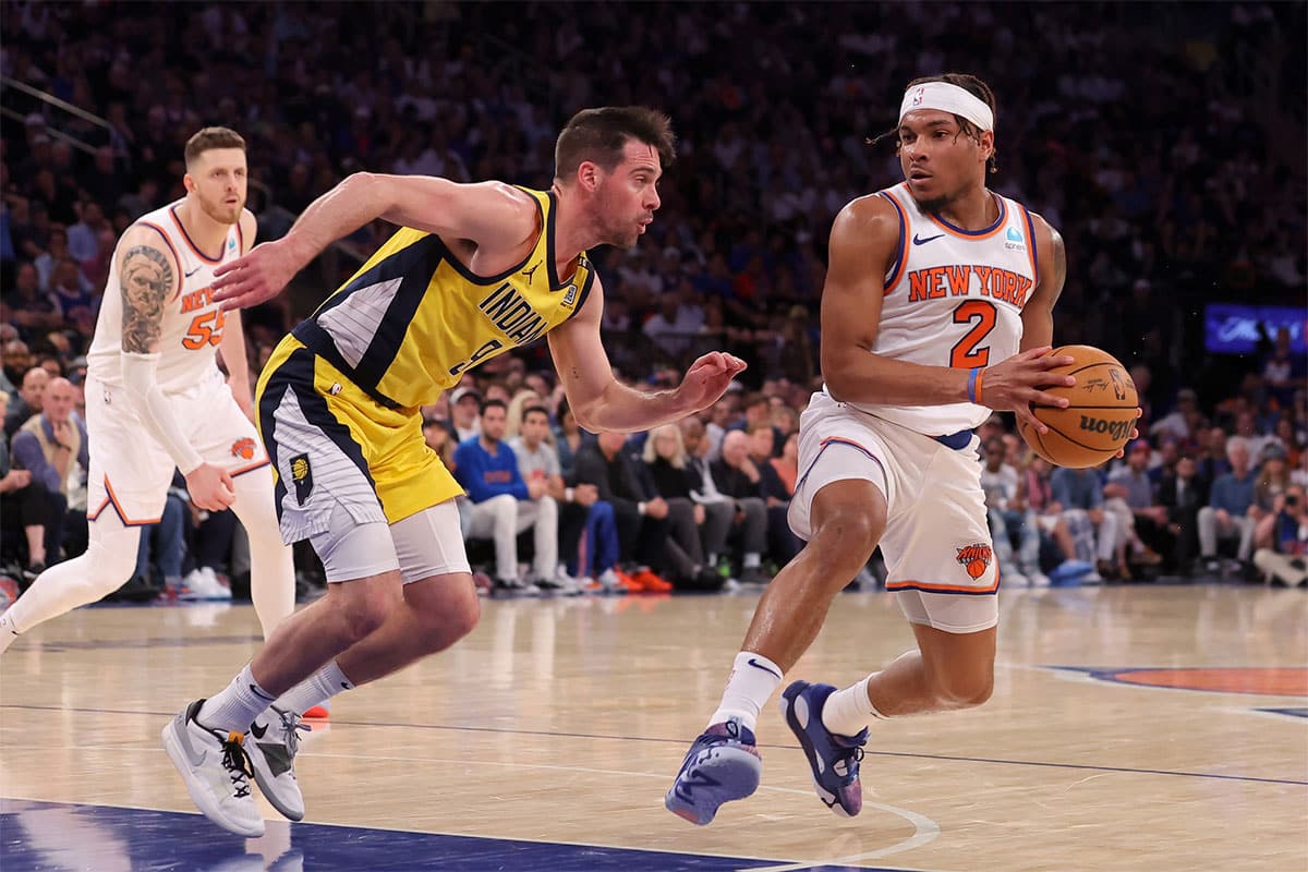 New York Knicks guard Miles McBride (2) drives to the basket against Indiana Pacers guard T.J. McConnell (9) during the fourth quarter of game seven of the second round of the 2024 NBA playoffs at Madison Square Garden. 