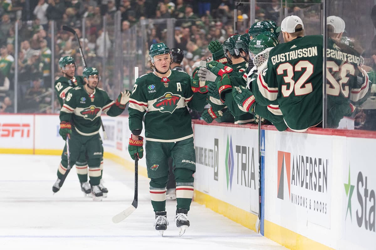 Minnesota Wild left wing Kirill Kaprizov (97) is congratulated by teammates after scoring on the Seattle Kraken in the first period at Xcel Energy Center.
