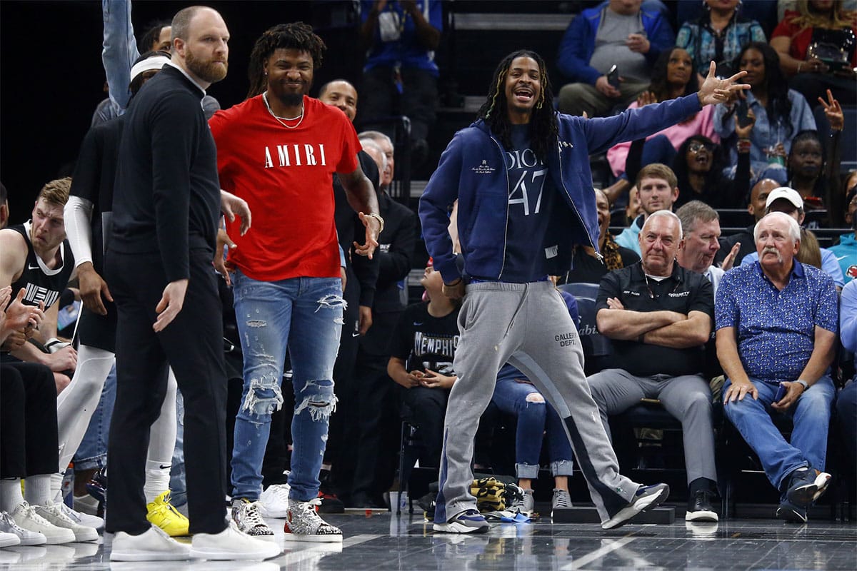 Memphis Grizzlies guard Marcus Smart (left) and Memphis Grizzlies guard Ja Morant (right) react from the bench duri