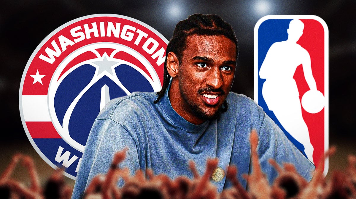 2024 NBA Draft prospect Alex Sarr stands next to Wizards logo, Hawks logo in background