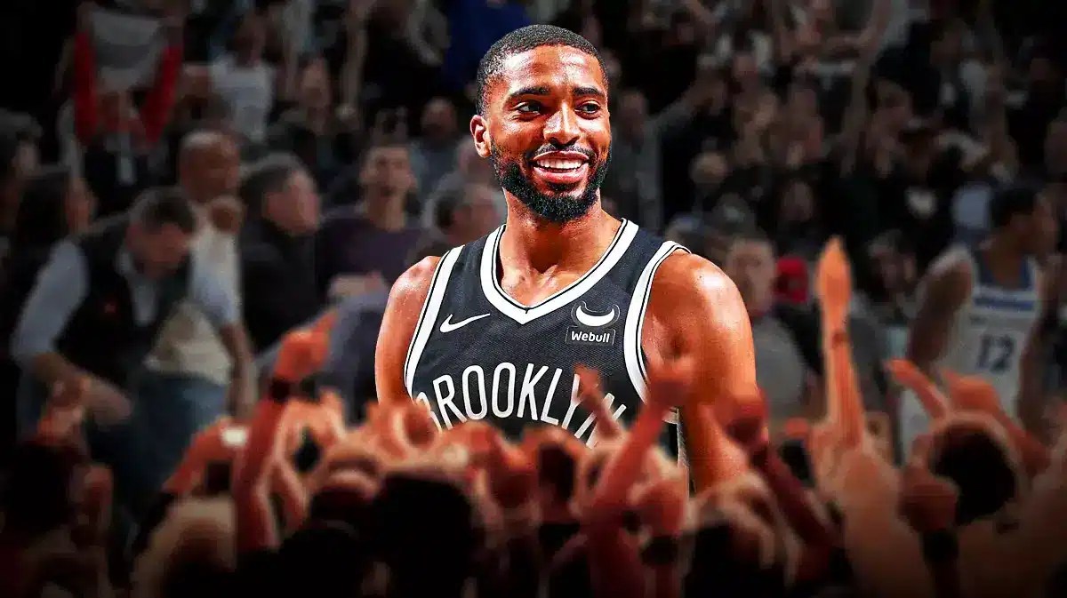 Mikal Bridges smiling with fans cheering