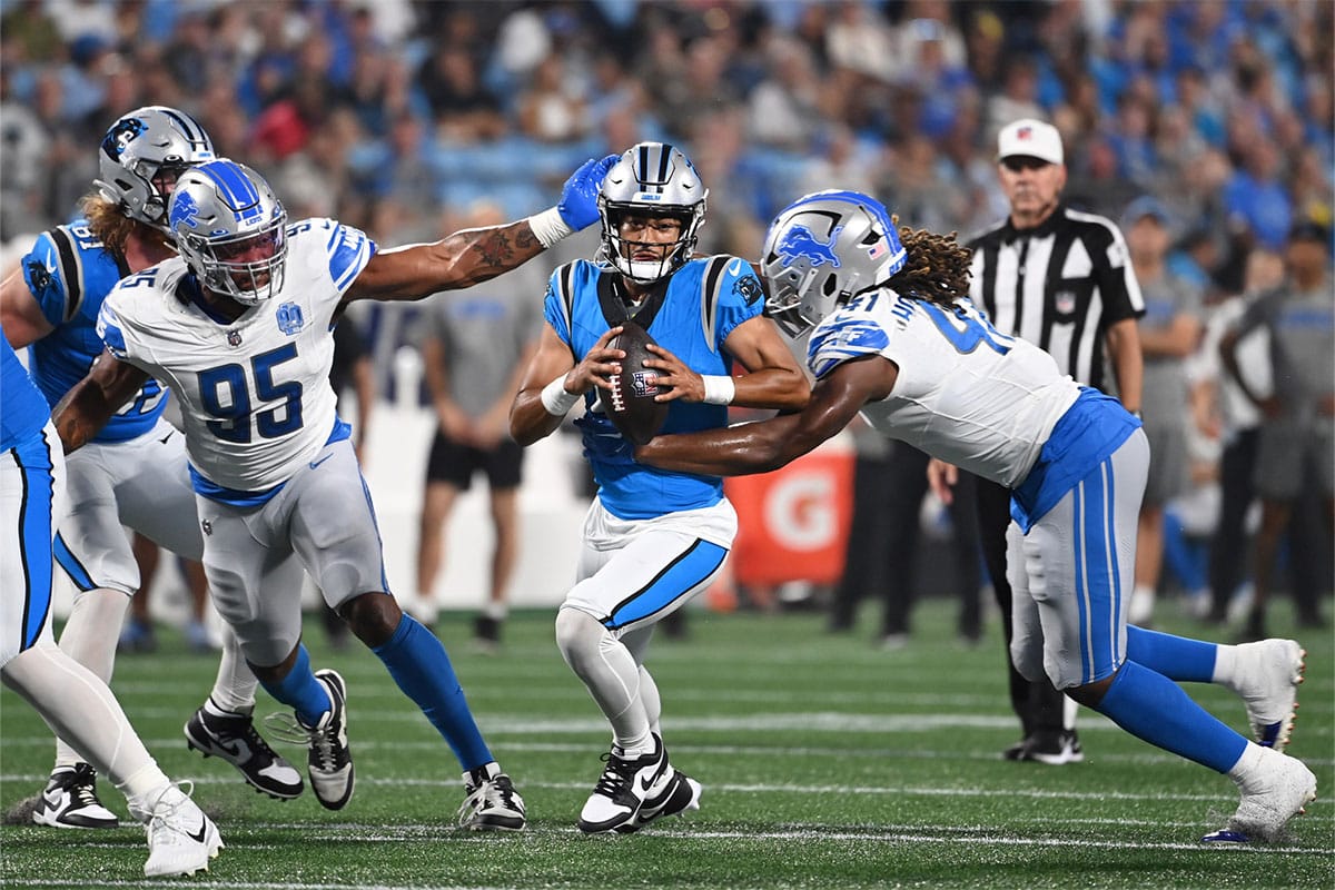 Carolina Panthers quarterback Bryce Young (9) is sacked by Detroit Lions linebacker James Houston (41) as defensive end Romeo Okwara (95) helps defend in the first quarter at Bank of America Stadium.