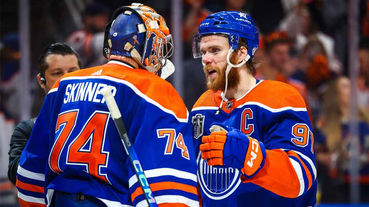 Edmonton Oilers goaltender Stuart Skinner (74) and center Connor McDavid (97) celebrates win after defeating Florida Panthers in game six of the 2024 Stanley Cup Final at Rogers Place.