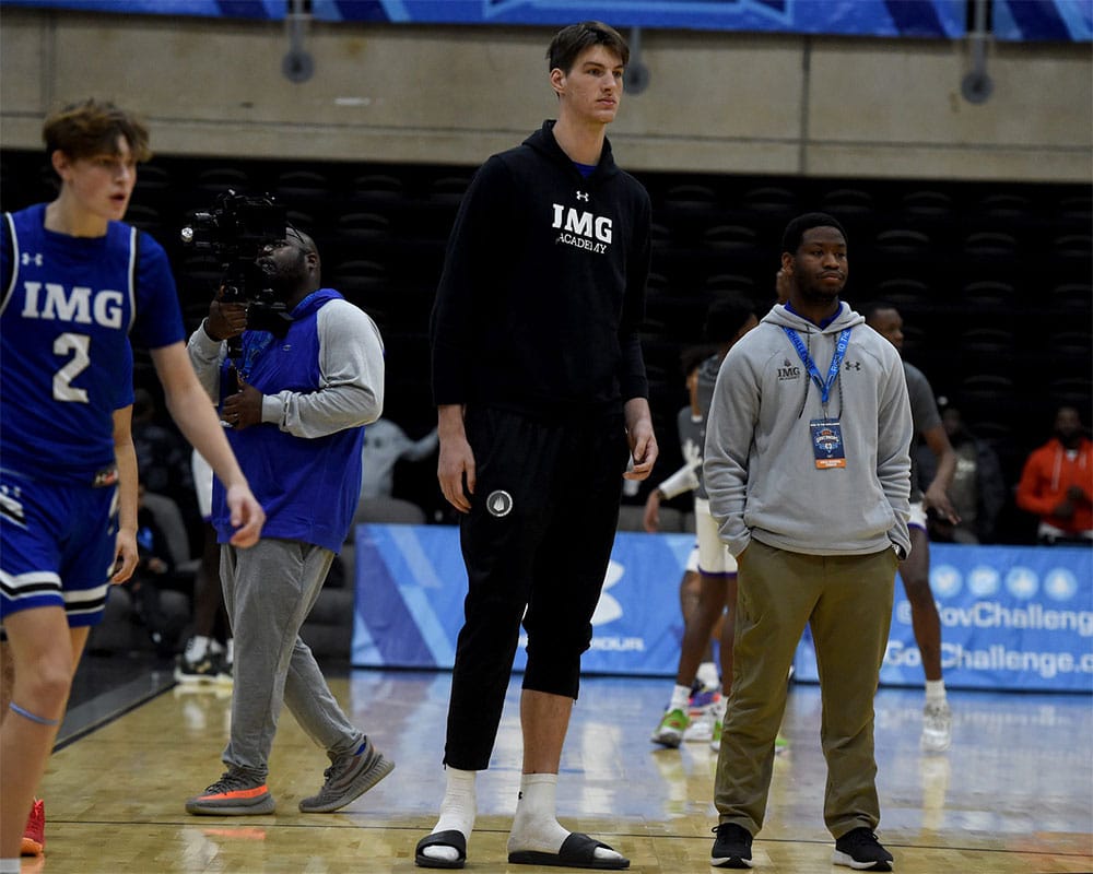 IMG Blue's Olivier Rioux, tallest teenager and high school basketball player in the world, watches as his team warms up for their game against Keystone in the Governors Challenge at Wicomico Civic Center