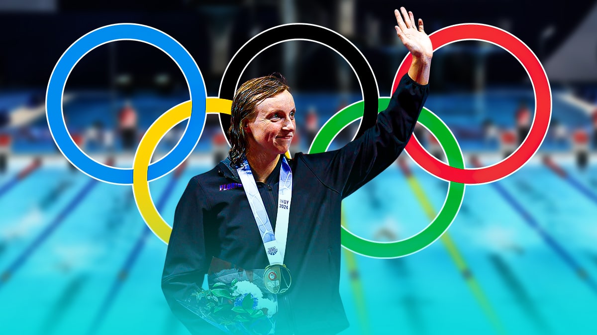 Katie Ledecky celebrating with the olympic logo in the background.