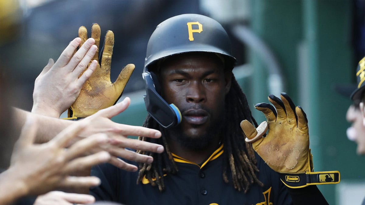 Pittsburgh Pirates shortstop Oneil Cruz (15) high-fives in the dugout after scoring a run against the Minnesota Twins during the eighth inning at PNC Park. Pittsburgh won 4-0.