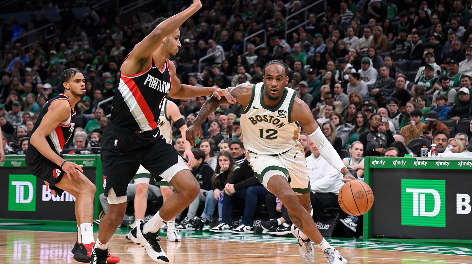 Boston Celtics forward Oshae Brissett (12) drives to the basket against Portland Trail Blazers forward Kris Murray (8) during the second half at TD Garden.