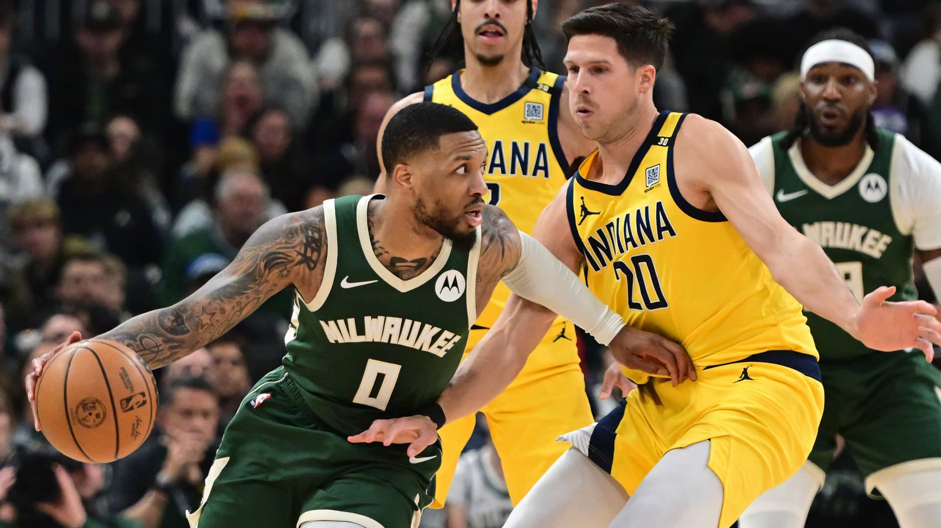 Milwaukee, Wisconsin, USA; Milwaukee Bucks guard Damian Lillard (0) drives for the basket against Indiana Pacers forward Doug McDermott (20) in the in the second quarter during game one of the first round for the 2024 NBA playoffs at Fiserv Forum. 