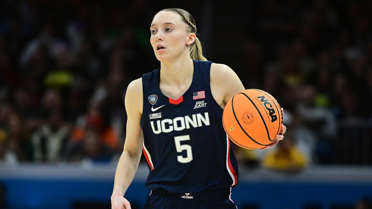 Connecticut Huskies guard Paige Bueckers (5) dribbles the ball against the Iowa Hawkeyes in the semifinals of the Final Four of the womens 2024 NCAA Tournament.