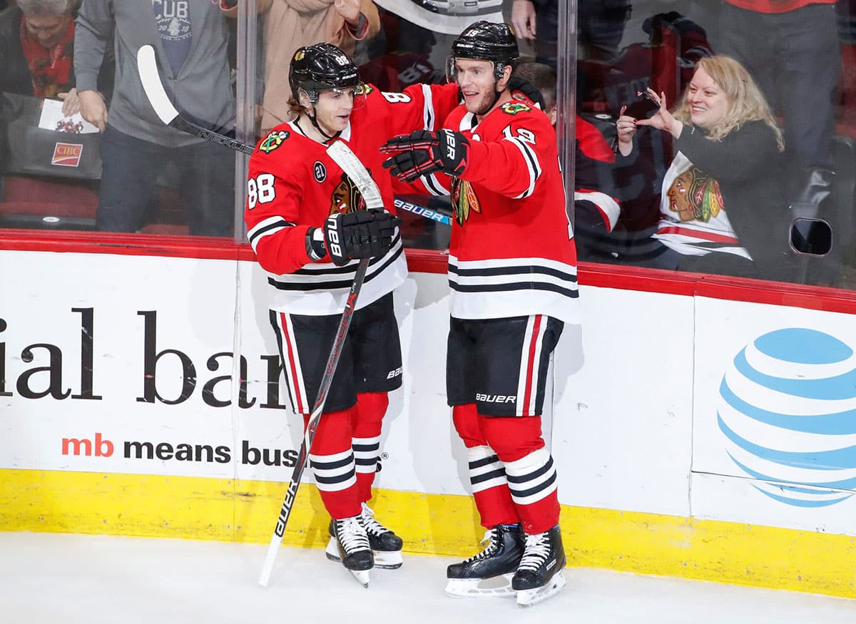 Chicago Blackhawks center Jonathan Toews (19) celebrates with right wing Patrick Kane (88) after scoring against the Vancouver Canucks during the first period at United Center. 