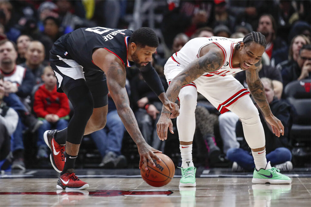 LA Clippers guard Paul George (13) steals the ball from Chicago Bulls forward DeMar DeRozan (11) during the first half at United Center.