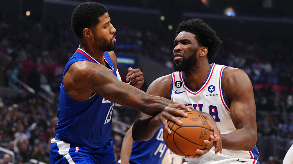 Philadelphia 76ers center Joel Embiid (21) is fouled by LA Clippers guard Paul George (13) in the first half at Crypto.com Arena.