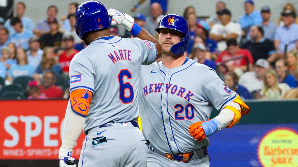 New York Mets first baseman Pete Alonso (20) celebrates with New York Mets right fielder Starling Marte (6) after hitting a two-run home run during the sixth inning against the Texas Rangers at Globe Life Field.