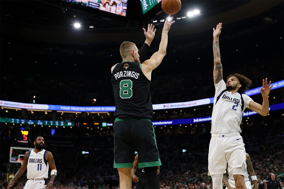 Boston Celtics center Kristaps Porzingis (8) shoots the ball against Dallas Mavericks center Dereck Lively II (2) during the third quarter in game two of the 2024 NBA Finals at TD Garden.