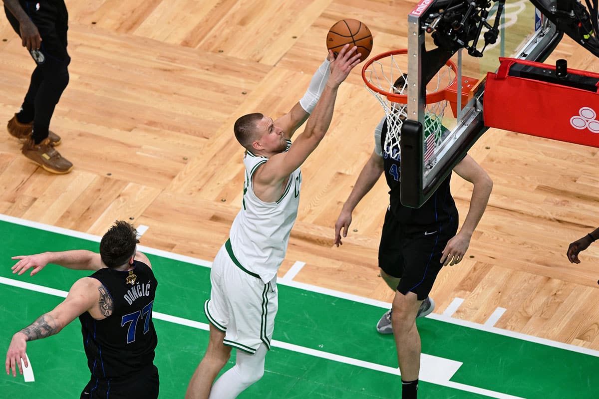 Boston, Massachusetts, USA; Boston Celtics center Kristaps Porzingis (8) dunks against the Dallas Mavericks during the second half of game one of the 2024 NBA Finals at TD Garden. Mandatory 