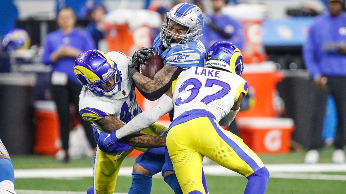 Detroit Lions running back David Montgomery runs against Los Angeles Rams safety Quentin Lake during the first half of the NFC wild-card game at Ford Field in Detroit on Sunday, Jan. 14, 2024.