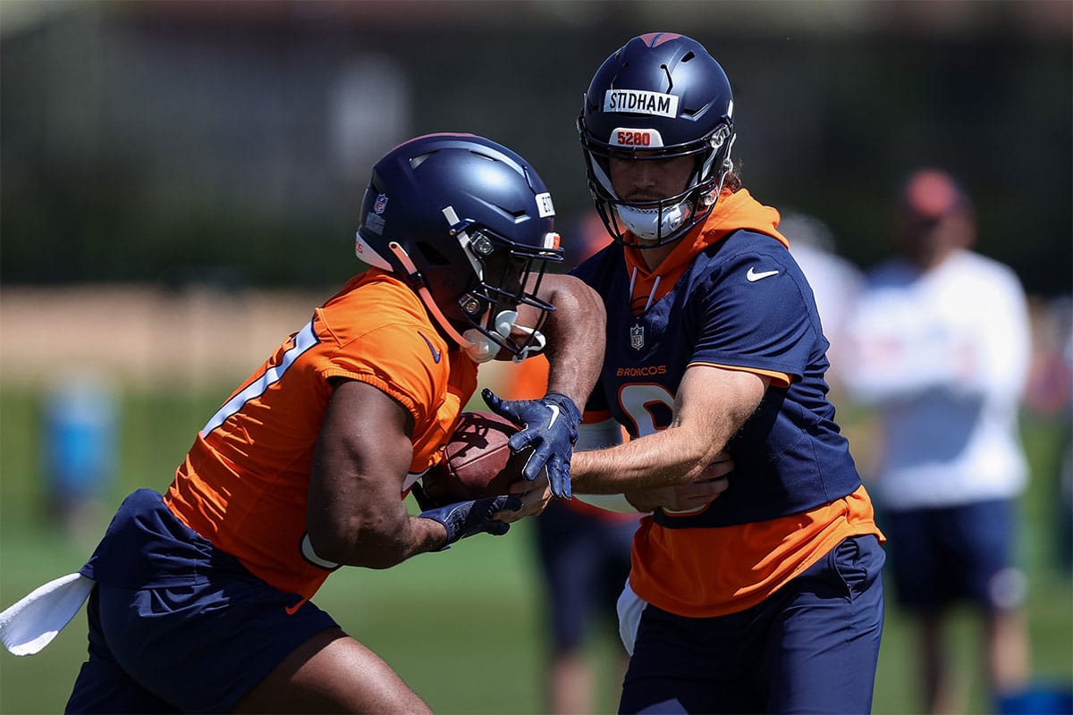 Denver Broncos quarterback Jarrett Stidham (8) and running back Audric Estime (37) during organized team activities at Centura Health Training Center.