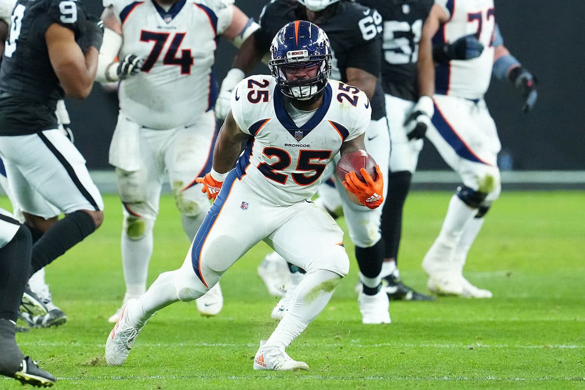 Denver Broncos running back Samaje Perine (25) gains yardage against the Las Vegas Raiders during the fourth quarter at Allegiant Stadium. 