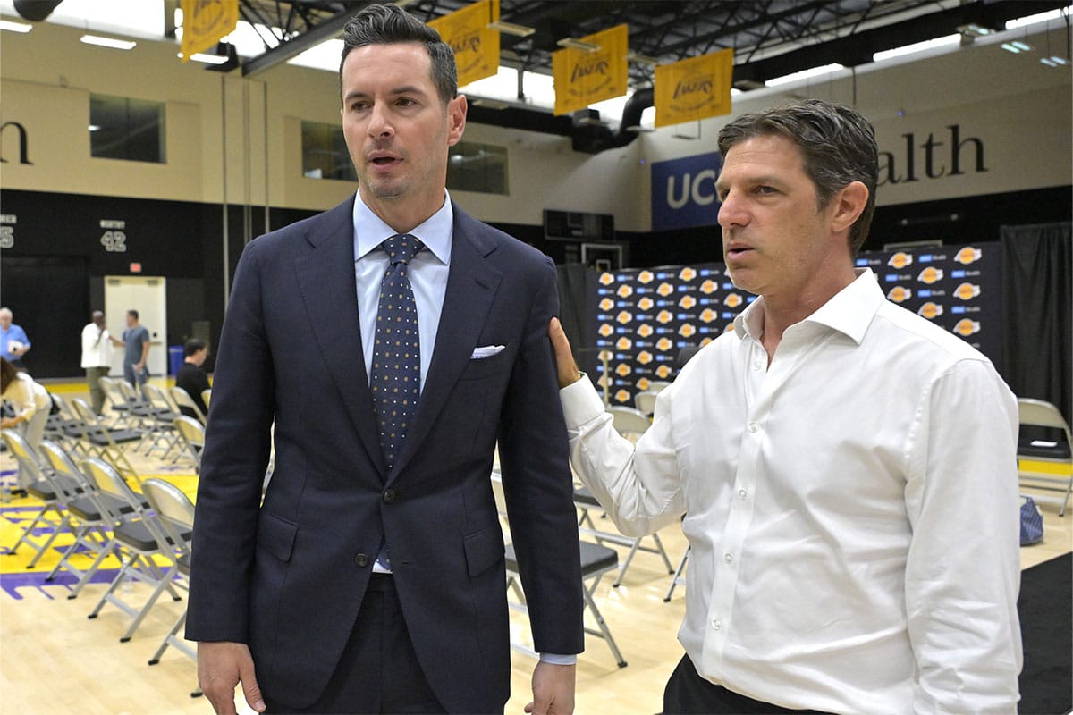 Los Angeles Lakers head coach JJ Redick talks with his agent Steven Heunann following his introductory news conference at the UCLA Health Training Center.