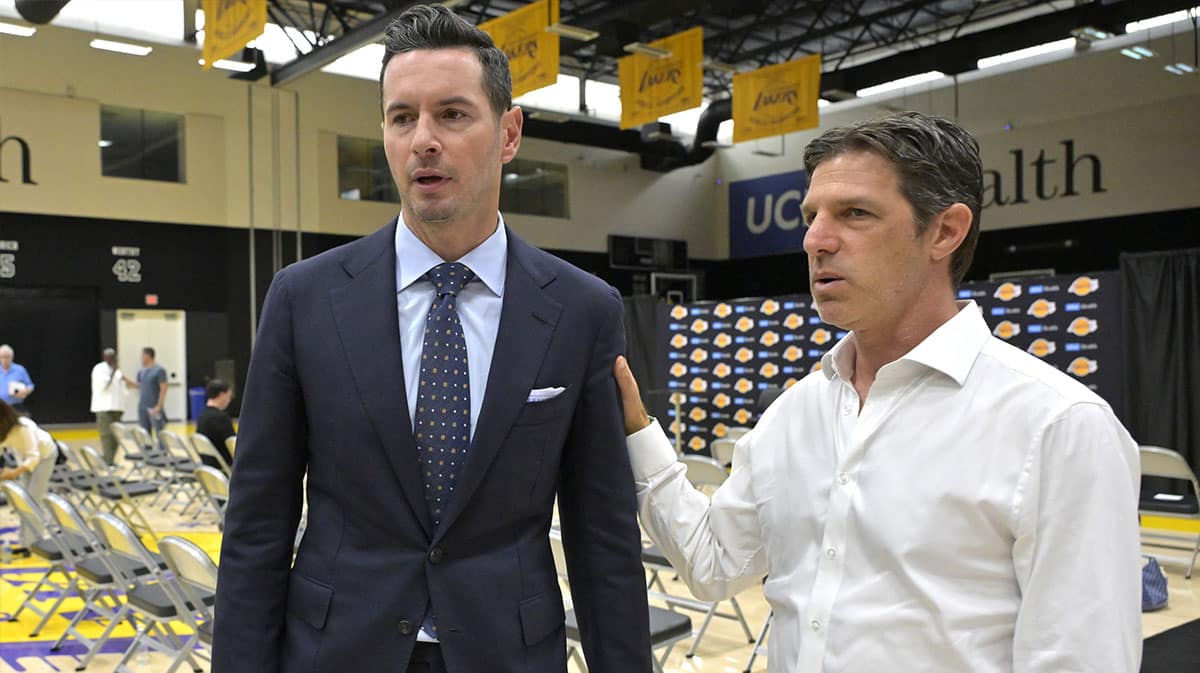Los Angeles Lakers head coach JJ Redick talks with his agent Steven Heunann following his introductory news conference at the UCLA Health Training Center.