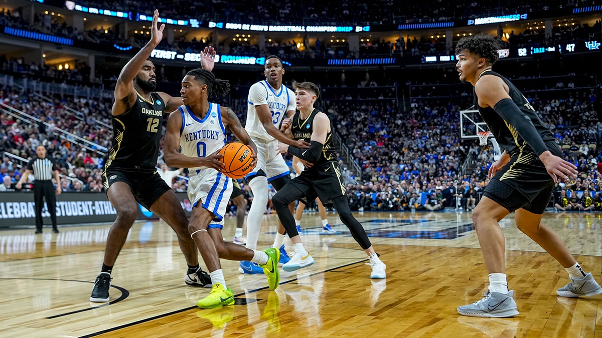 Kentucky Wildcats guard Rob Dillingham (0) handles the ball around Oakland Golden Grizzlies forward Tuburu Naivalurua (12) during the second half in the first round of the 2024 NCAA Tournament at PPG Paints Arena.