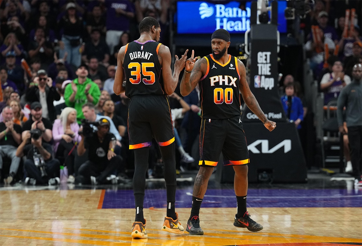 Phoenix Suns forward Kevin Durant (35) and Phoenix Suns forward Royce O'Neale (00) celebrate against the Minnesota Timberwolves during the first half of game four of the first round for the 2024 NBA playoffs at Footprint Center. 