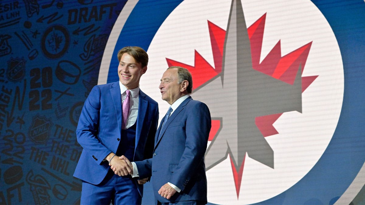 Rutger Mcgroarty shakes hands with NHL commissioner Gary Bettman after being selected as the number fourteen overall pick to the Winnepeg Jets in the first round of the 2022 NHL Draft at Bell Centre.