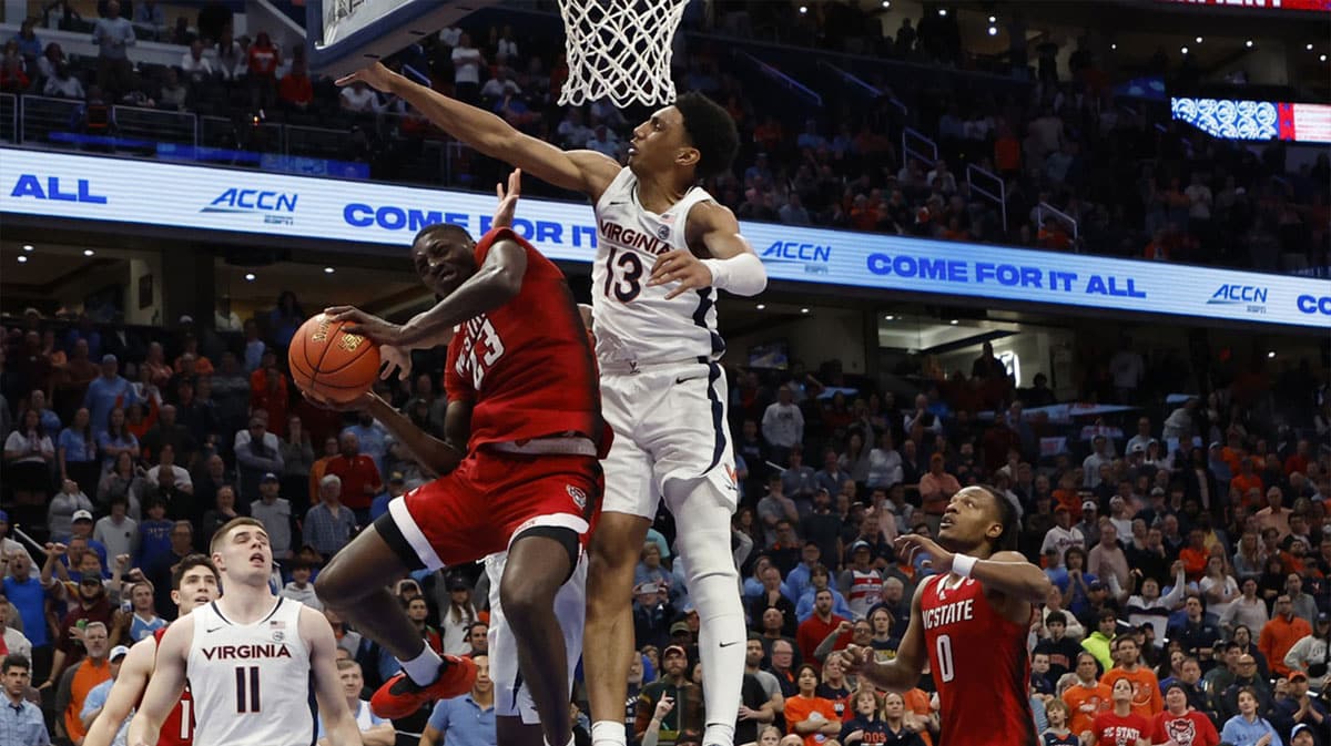 Mar 15, 2024; Washington, D.C., USA; North Carolina State Wolfpack forward Mohamed Diarra (23) shoots the ball as Virginia Cavaliers guard Ryan Dunn (13) defends in overtime at Capital One Arena. Mandatory Credit: Geoff Burke-USA TODAY Sports