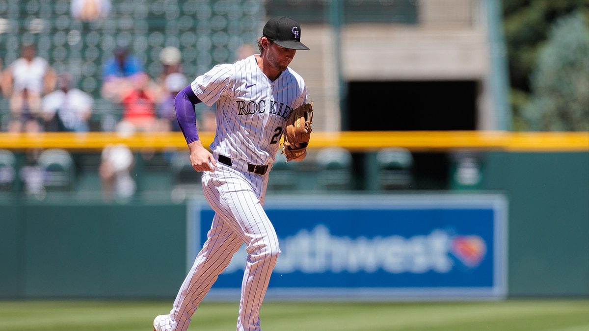 Colorado Rockies third base Ryan McMahon (24) runs to the dugout after catching a fly ball for an out during the first inning against the Cincinnati Reds at Coors Field.