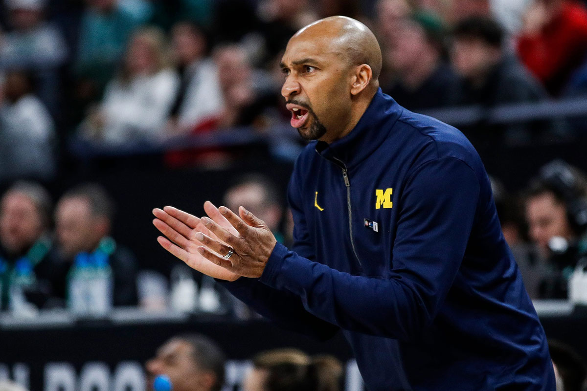 Michigan assistant coach Saddi Washington reacts to a play against Penn State during the second half of the First Round of Big Ten tournament at Target Center